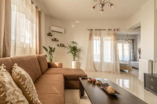 a living room with a couch and a table at Coastal Family House With SeaView in Heraklio Town