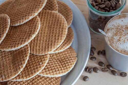 a plate of waffles and a cup of coffee at De Beijersche Stee , Landhuysje in Stolwijk