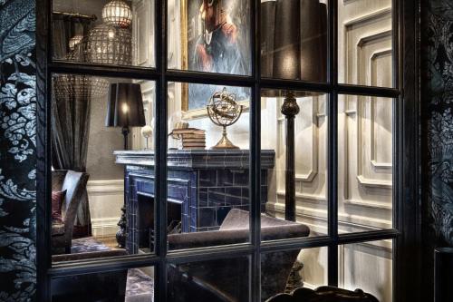 a glass window in a room with a fireplace at Vimmerby Stadshotell, WorldHotels Crafted in Vimmerby