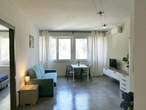 a living room with a couch and a table at Residence Casa Di Caccia in Marina di Bibbona