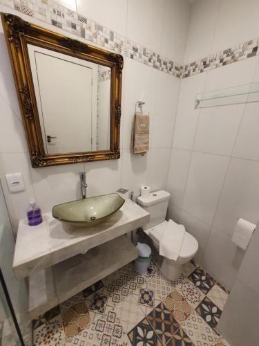 a bathroom with a sink and a toilet at Casa Villa Constanza in Itaipava