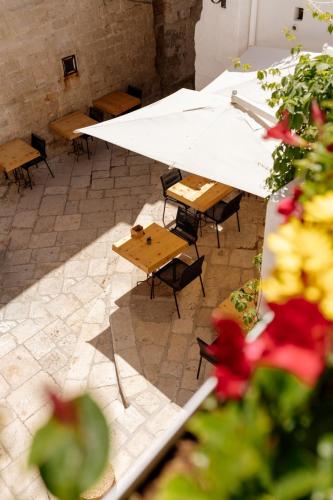 an overhead view of a patio with tables and benches at Aquamarea in Polignano a Mare