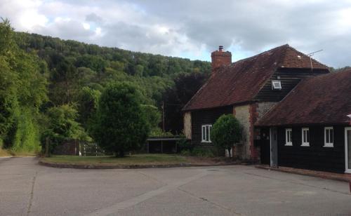 a house with a mountain in the background at The Old Smithy in Duneton