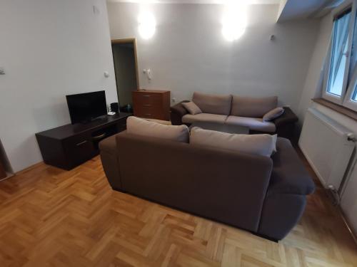 a living room with a couch and a tv at Zagrebska flat in Skopje