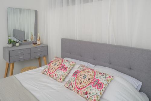 1 dormitorio con 1 cama con 2 almohadas en PRINCESS of the Dead Sea by CROWN, en Neve Zohar