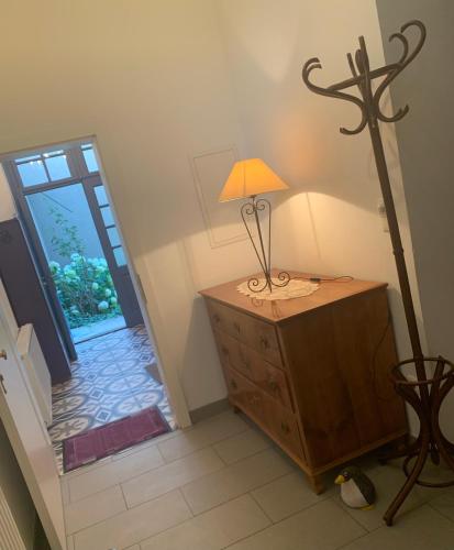 a lamp on a dresser in a room with a door at Villa Pazelt Top4 in Bad Vöslau