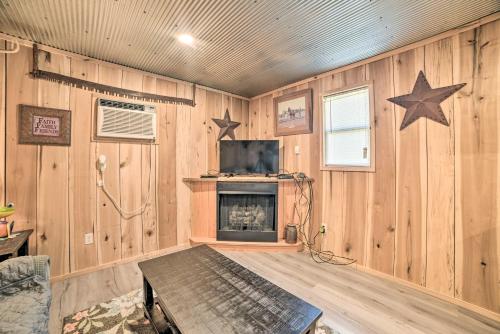 a living room with wooden walls with stars on the wall at Charming New Concord Cabin on 50-Acre Farm! in New Concord