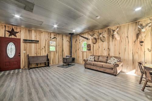 a living room with a couch and a tv in it at Charming New Concord Cabin on 50-Acre Farm! in New Concord