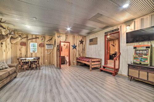 a living room with a couch and a table at Charming New Concord Cabin on 50-Acre Farm! in New Concord