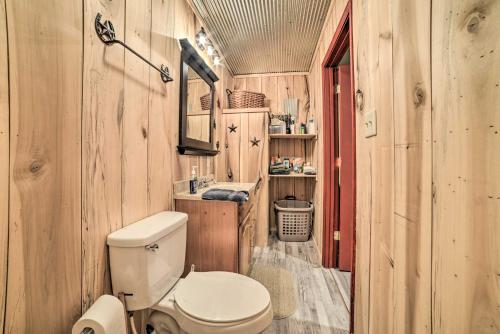 a bathroom with a toilet and a sink at Charming New Concord Cabin on 50-Acre Farm! in New Concord