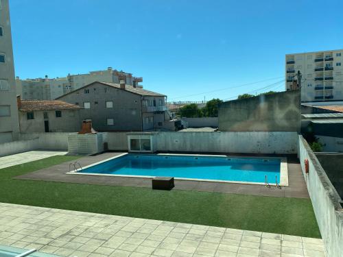 a swimming pool on the roof of a building at OndasDaVagueira - T2 em condomínio com piscina in Gafanha da Boa Hora
