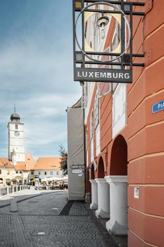 a sign on the side of a building on a street at Hotel Casa Luxemburg in Sibiu