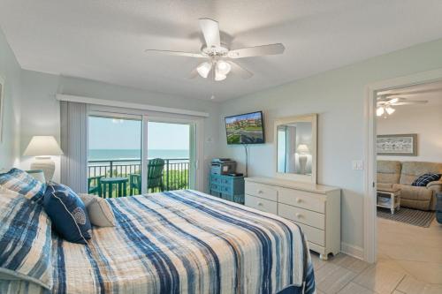 a bedroom with a bed and a view of the ocean at Windjammer 209 in St. Augustine