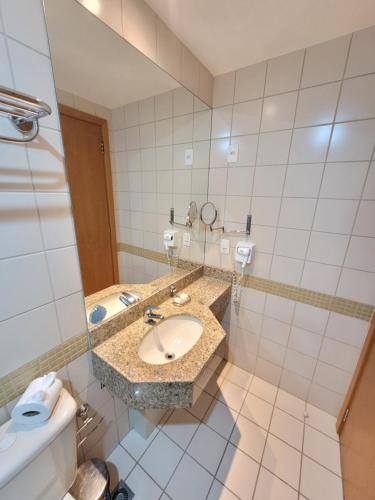 a bathroom with a sink and a toilet at Flat Nobile Suítes Monumental By Rei dos Flats, in Brasilia