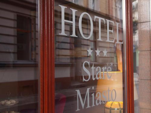 a window of a store with a sign on it at Hotel Stare Miasto Old Town in Poznań