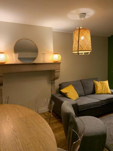 un salon avec un canapé et une table dans l'établissement Maison de charme - Au coeur de Puligny-Montrachet, à Puligny-Montrachet