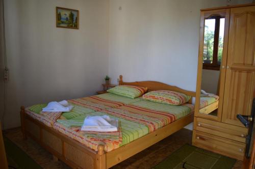 a bedroom with a bed with towels on it at Guest house Nedyalkovi in Chernomorets
