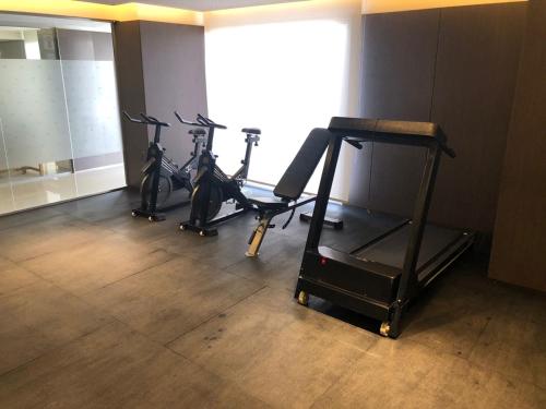 a gym with three bikes parked in a room at Apart France - Con gim, piscina y estacionamiento in Río Cuarto