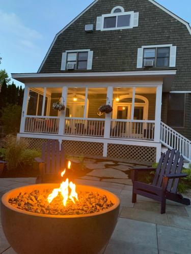 a fire pit in front of a house at White Sails Inn in Kennebunk