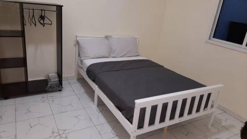 Bett in einem schwarz-weißen Zimmer in der Unterkunft Matano Guest House in Brikama