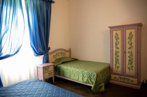 a bedroom with a bed and a dresser and a window at La Villetta Food & Drink Rooms for Rent - No Reception - in LʼAquila