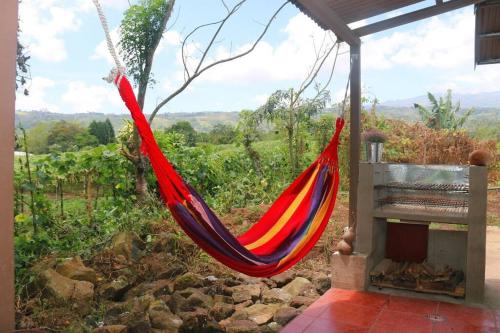 a hammock hanging from a building with a view at Casa y Campo in Cachí