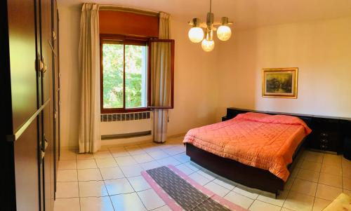 a bedroom with a bed and a window at Peaceful Country Living at Apartments at Villa Clara in Vimignano