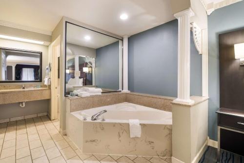 a large bathroom with a tub and a sink at Best Western Inn Winchester in Winchester