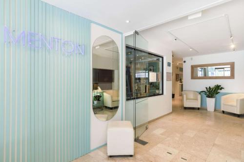 a lobby with a mirror and a room at Best Western Hotel Mediterranee Menton in Menton