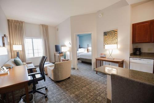 a large hotel room with a living room and a bedroom at Sonesta ES Suites Baton Rouge University at Southgate in Baton Rouge