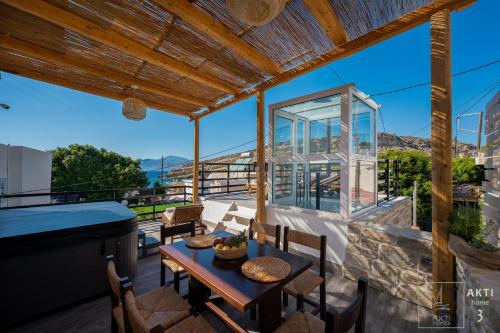 a view from the balcony of a house with a table and chairs at AKTI Homes Matala in Matala