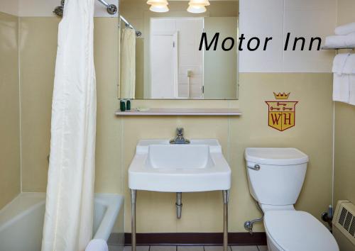 a bathroom with a sink and a toilet and a mirror at Finlen Hotel and Motor Inn in Butte