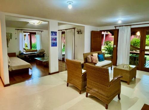 sala de estar con sofá, mesa y sillas en Charm Bahia Residencias, en Arraial d'Ajuda