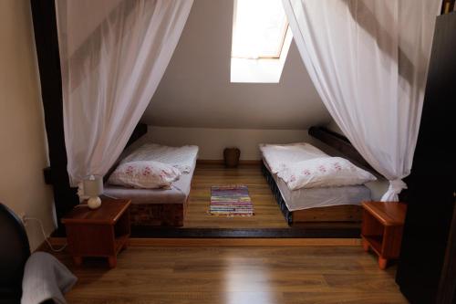 two beds in a small room with a window at Tatry Liptov in Jakubovany