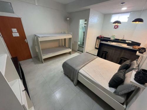 a bedroom with a bed and a sink in it at Central Praias Suite 1 in Cabo Frio