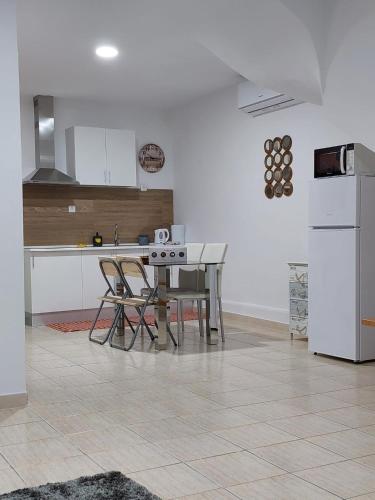 a kitchen with a table and chairs and a refrigerator at charming loft in Porto in Porto