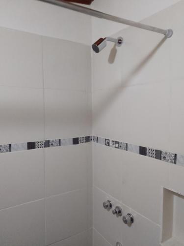 a shower with a shower head in a bathroom at Ushuaia de las Nieves B&B in Ushuaia