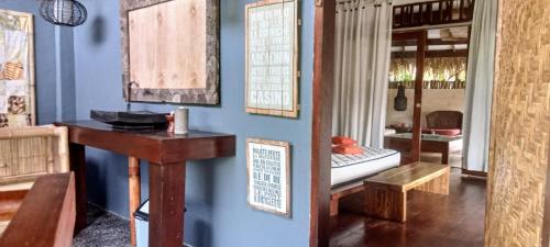 a room with blue walls and a table and a bench at Tanjungan in Gili Gede