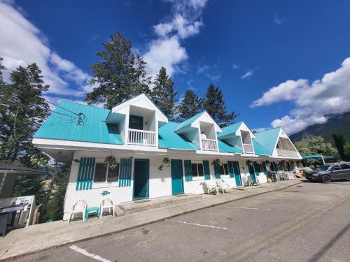 a building with a blue roof on a street at AppleTree Inn in Radium Hot Springs