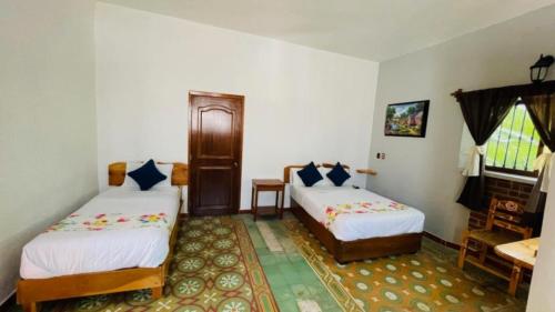 Ένα ή περισσότερα κρεβάτια σε δωμάτιο στο HOTEL EX HACIENDA EL MOLINO