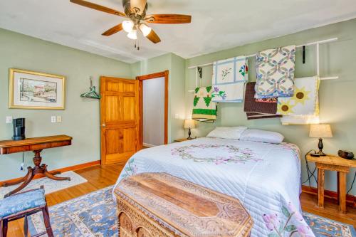 a bedroom with a bed and a ceiling fan at Birdsong Rambler in Weaverville