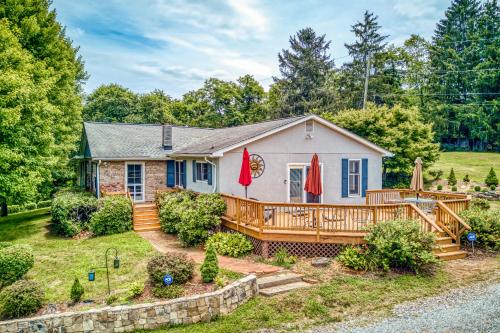 a home with a large deck and a house at Birdsong Rambler in Weaverville