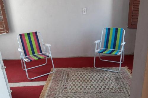 two chairs sitting next to each other in a room at Chalé do Coqueiro in Luis Correia