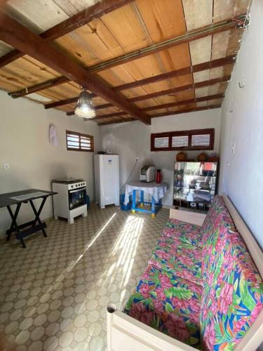a room with a bed and a table in it at Chalé do Coqueiro in Luis Correia
