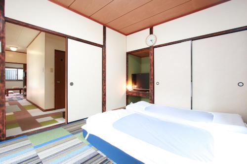 Ένα ή περισσότερα κρεβάτια σε δωμάτιο στο Ramune Onsen Senju no Sato