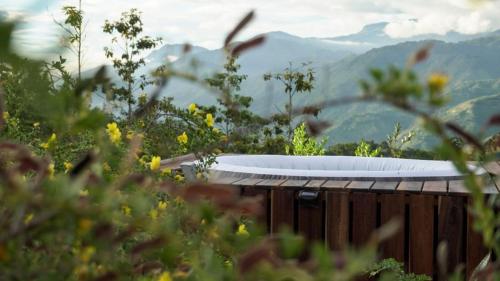 a white bath tub sitting on top of a wooden fence at Jardín Satori Glamping in Piedecuesta