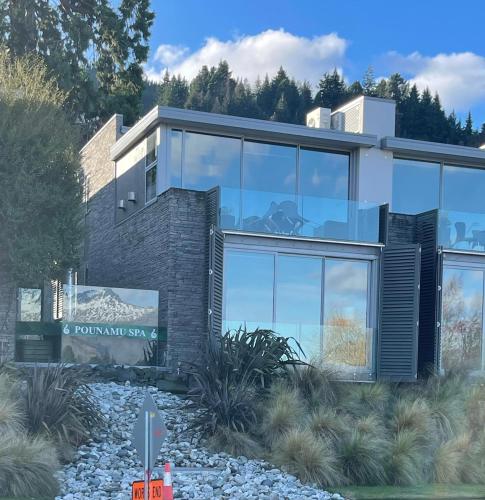 a rendering of a modern house with glass at Hello QT Pounamu in Queenstown