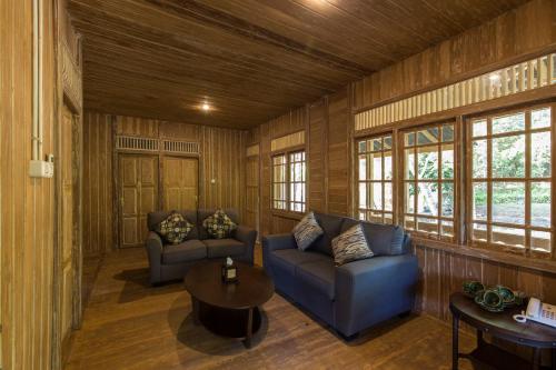 a living room with a couch and a table at Menjangan Ecolodge - CHSE Certified in Banyuwedang