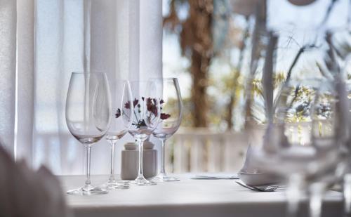 a group of wine glasses sitting on a table at Hotel Lungomare Opatija - Liburnia in Opatija