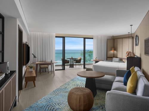a hotel room with a bed and a living room at Crowne Plaza Phu Quoc Starbay by IHG in Phu Quoc